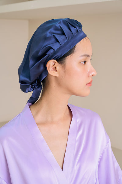 asian model wears blue silk sleep cap 
